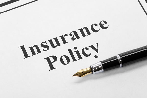 Insurance policy with a pen on it