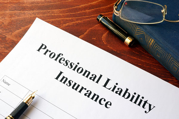 Professional liability insurance form with a pen on top of it