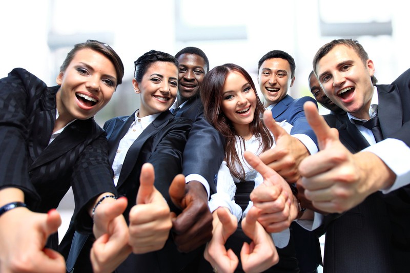 Group of businesspeople giving thumbs up