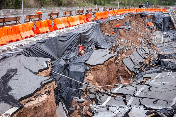 A large sinkhole on the road and a protection site around it