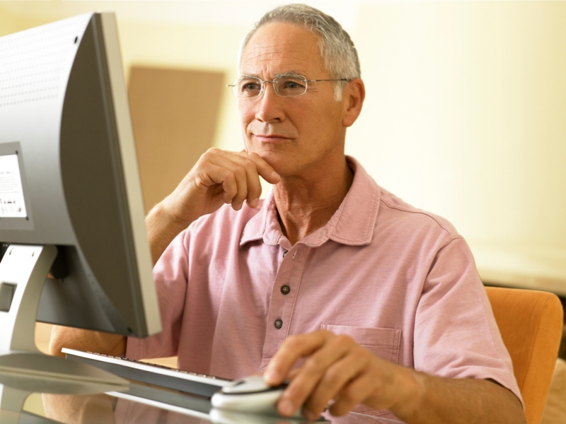 Close-up of older man on a computer