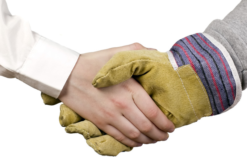 Businessman and construction worker shaking hands