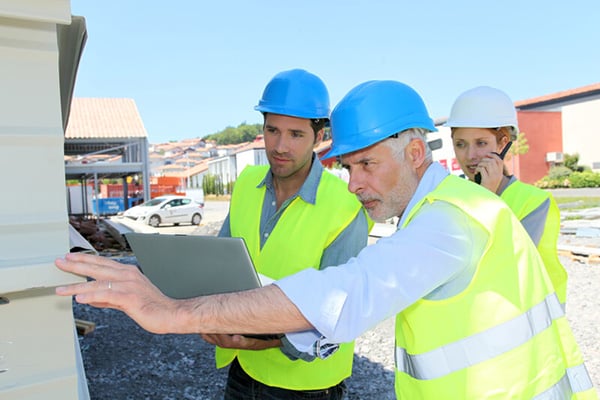 Construction workers checking building