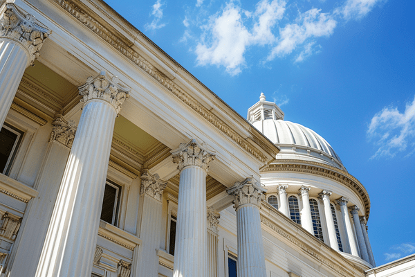 The top of a domed court building against a blue sky