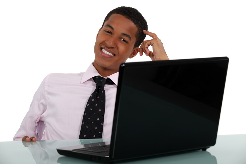 Businessman with laptop scratching his head
