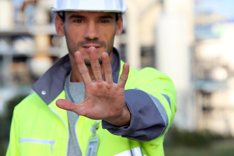 Construction worker holding out his hand