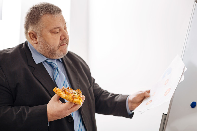 Large businessman eating lunch