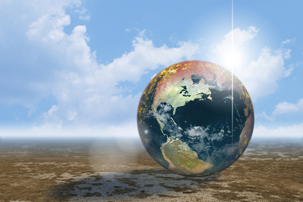 A giant globe on top of barren soil