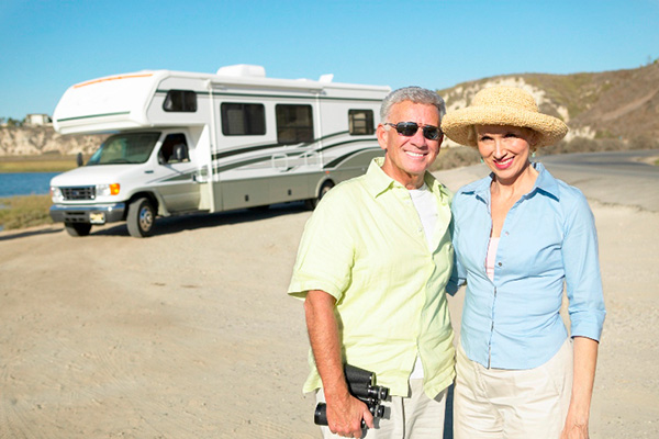 Couple standing in front of their RV