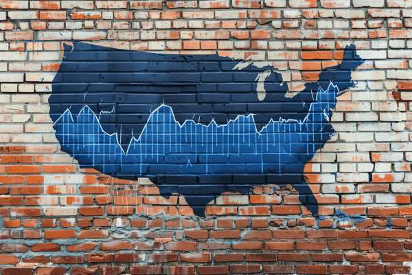 A blue map of the United States with a line graph across it painted on a brick wall