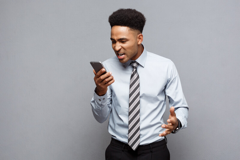 Businessman angry at cell phone