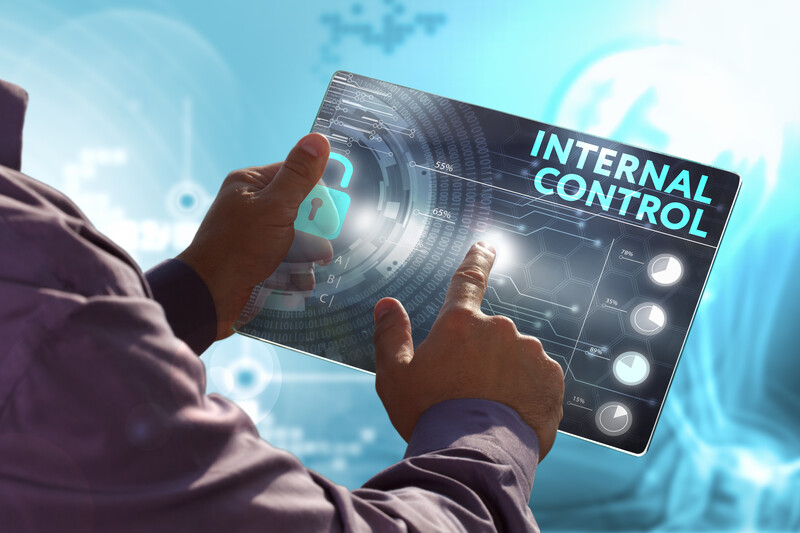Man's hands holding tablet that says internal control