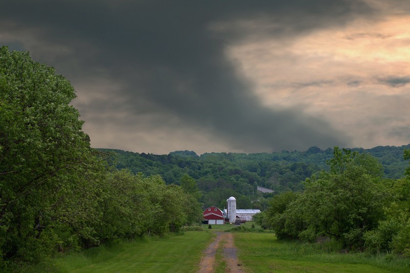 Tornado behind a farm
