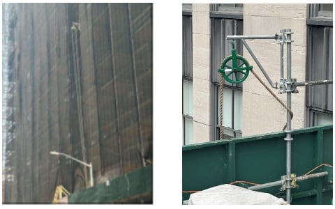 hoist on a side of a building and free-wheeling pulley on a rooftop