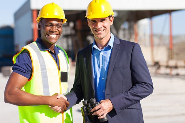 Construction workers shaking hands