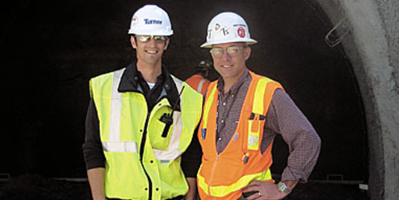 Two men in white hard hats and safety vests