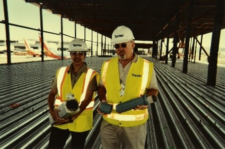 Two construction workers at an airport