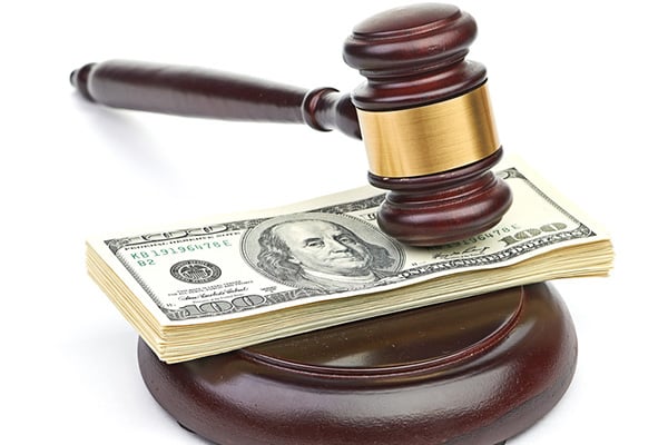 Gavel on a stack of $100 bills