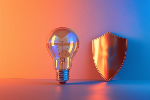 An unlit light bulb sits upright next to a bronze shield