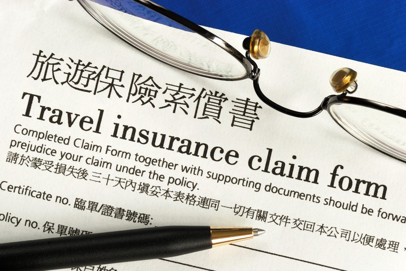 Travel insurance claim form with a pen on it