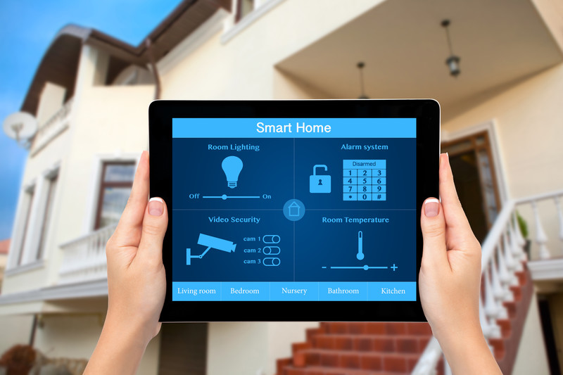 Smart home tablet control in front of a house