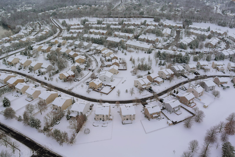 Aerial view of snow covered houses in a subdivision