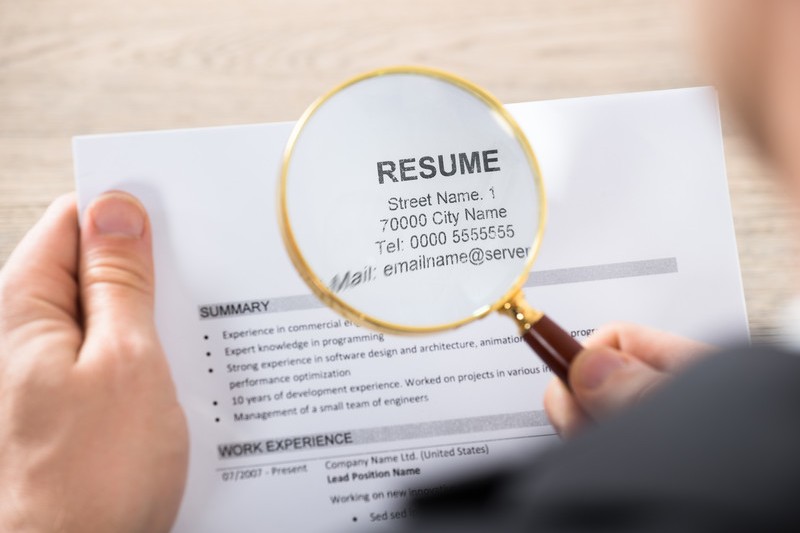 Magnifying glass looking at a resume