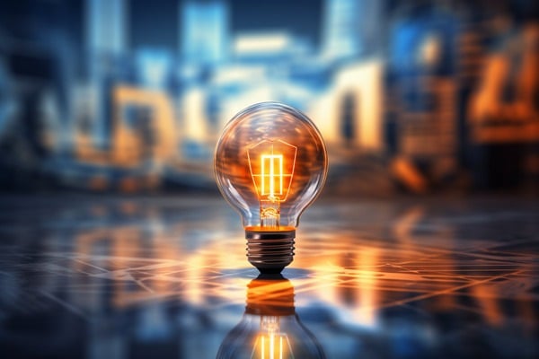 A glowing lightbulb in front of an abstract background