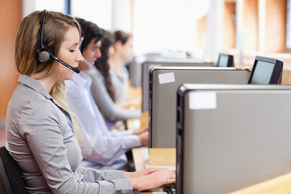 Woman working in call center in front of computer