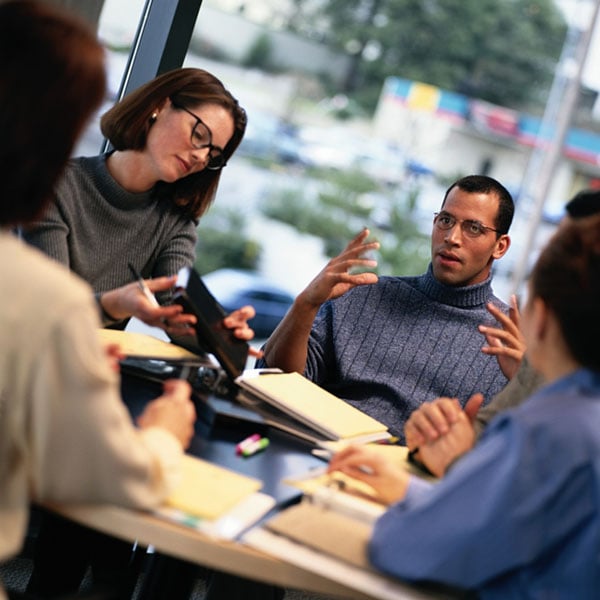 Businesspeople talking around a conference table