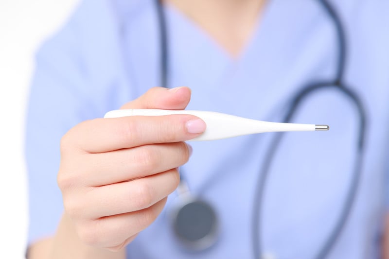 Doctor holding a thermometer