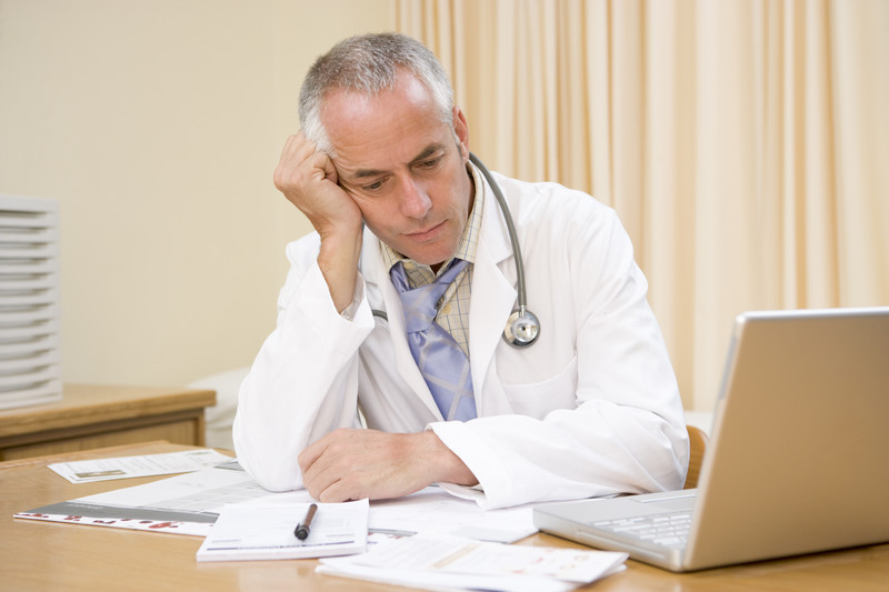 Frustrated doctor working on paperwork