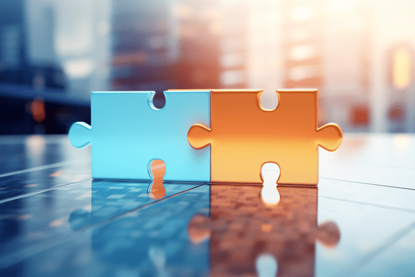 Blue and orange connected puzzle pieces on top of a reflective table in front of skyscrapers in the distance