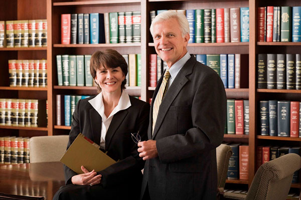 Businesspeople working in library and smiling