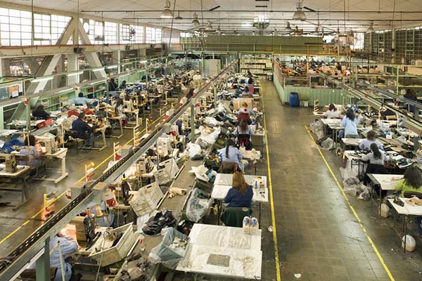 Factory from above with many workers working at desks